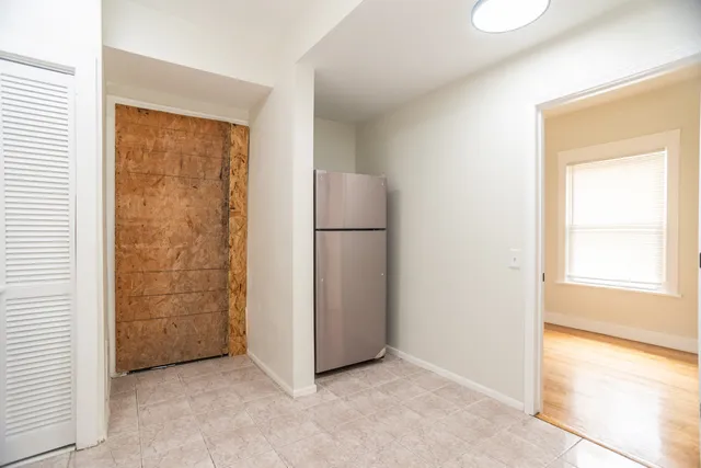 an empty room with windows and closet