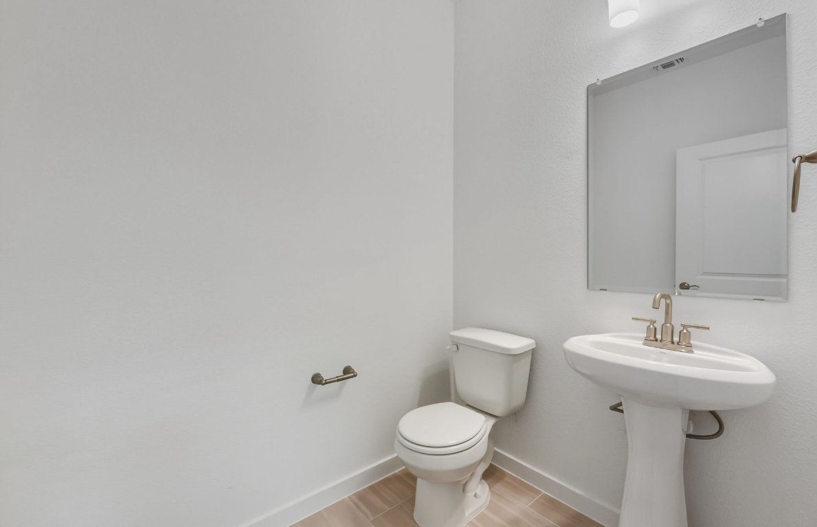 480 Tailwind Drive Kyle, TX 78640 - Photo 12 of 17 a bathroom with a sink toilet and mirror