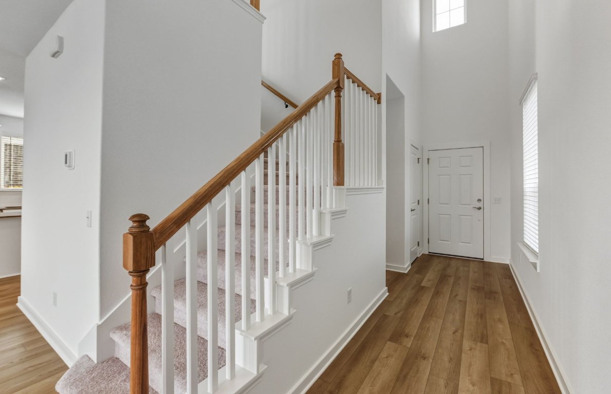 480 Tailwind Drive Kyle, TX 78640 - Photo 2 of 17 a view of a hallway with wooden floor and staircase