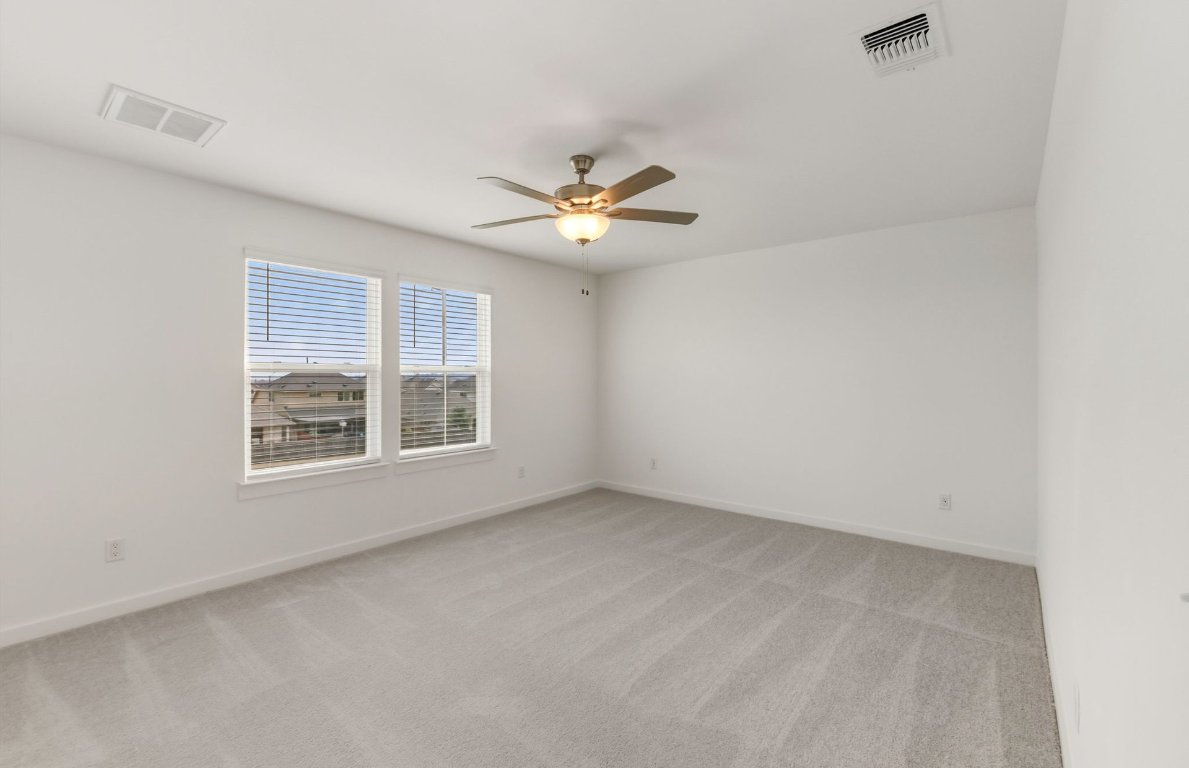480 Tailwind Drive Kyle, TX 78640 - Photo 7 of 17 an empty room with a window and a ceiling fan