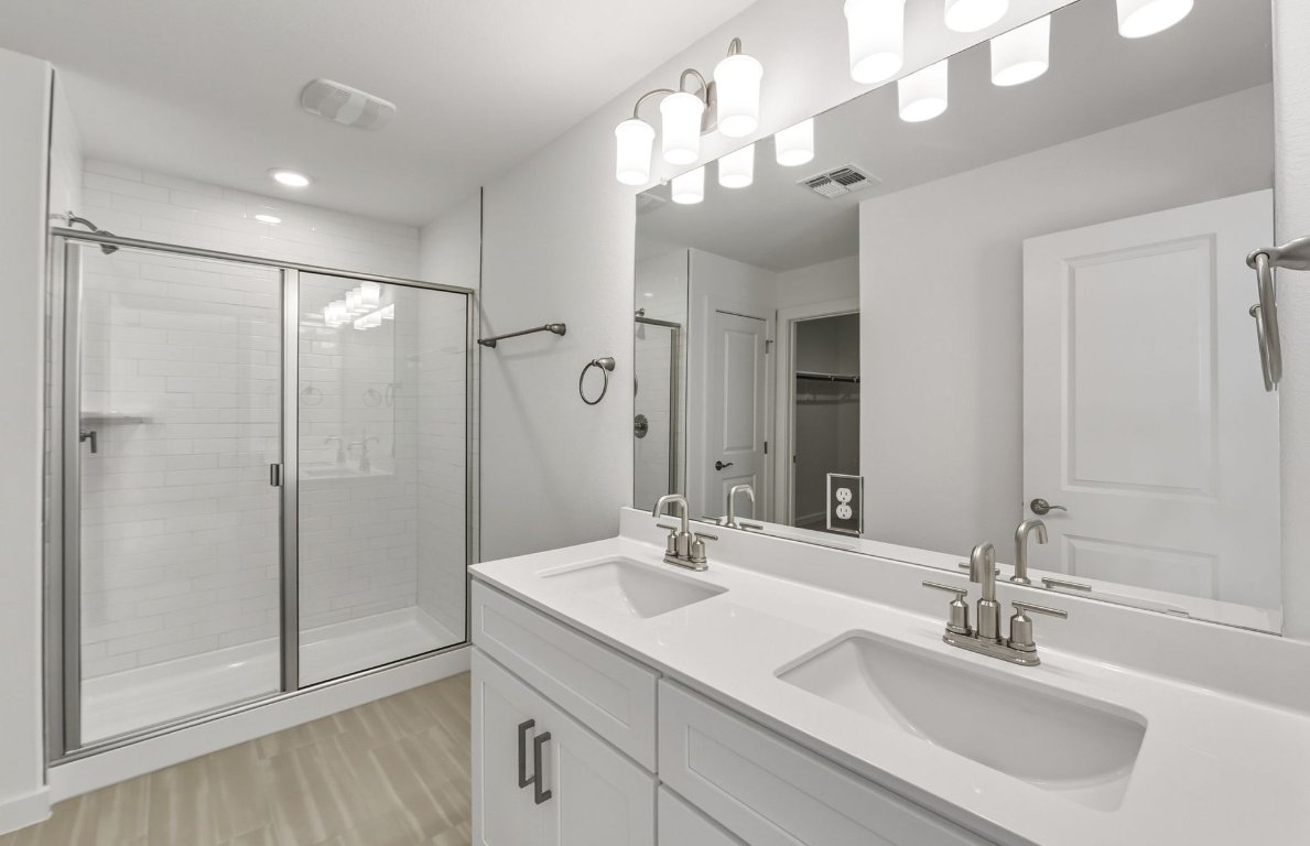 480 Tailwind Drive Kyle, TX 78640 - Photo 8 of 17 a bathroom with a sink double vanity and shower