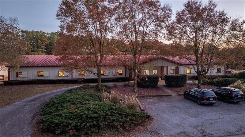 3055 A Spring Hill Drive Monroe, GA 30656 - Photo 45 of 65 a front view of a house with a garden and trees