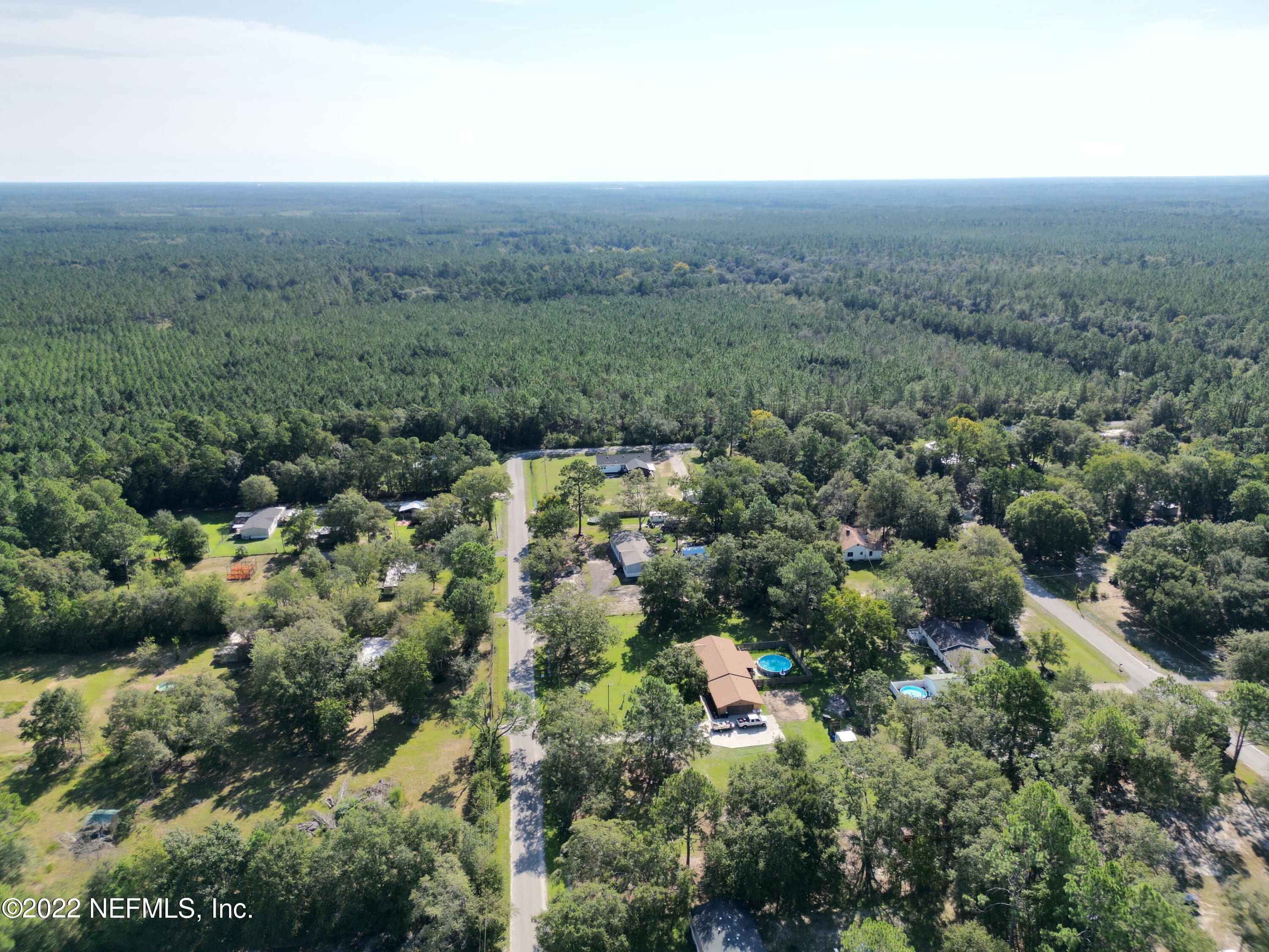 2268 D E Long Road Macclenny, FL 32063 - Photo 8 of 14 an aerial view of a houses with outdoor space and trees