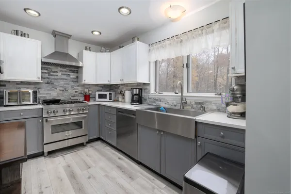 a kitchen with a sink window and cabinets