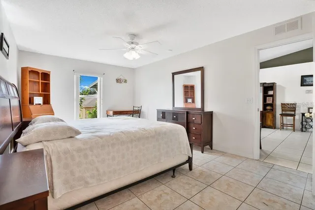 a bedroom with a large bed and a chandelier