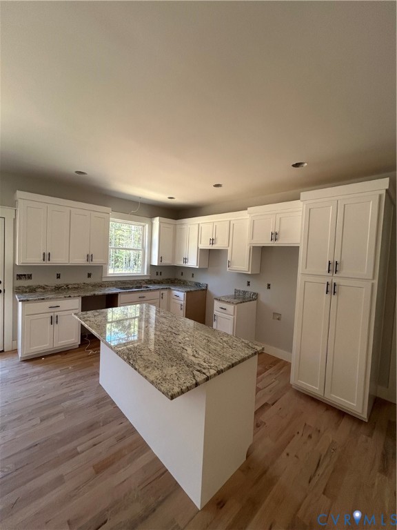 19106 Carson Road Dinwiddie, VA 23841 - Photo 4 of 10 Kitchen featuring white cabinetry, a central islan