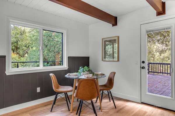 a dining room with furniture a rug and wooden floor