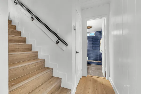 a view of entryway and hall with wooden floor