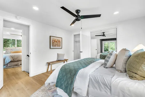 a bedroom with a large bed and a chandelier
