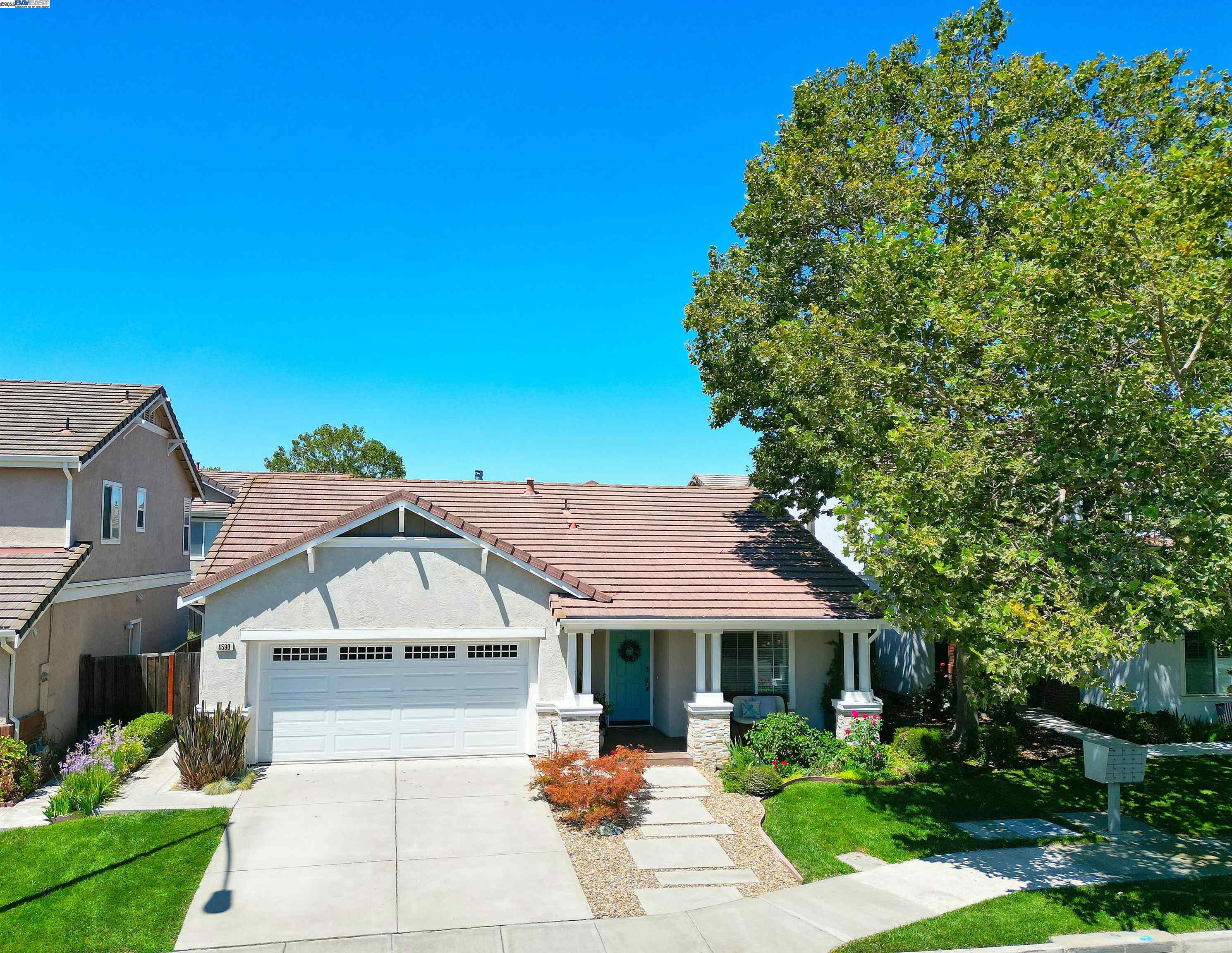 a front view of a house with a garden