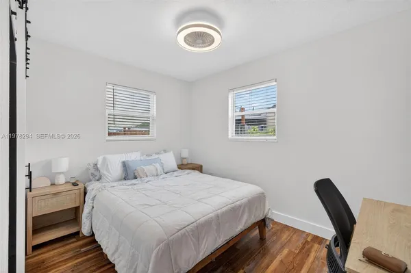 a view of a room with wooden floor and window