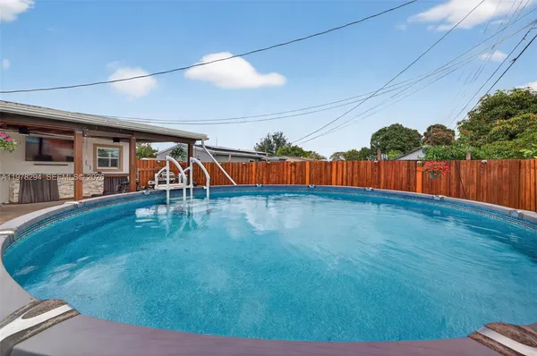 an aerial view of a house with a swimming pool yard and outdoor seating