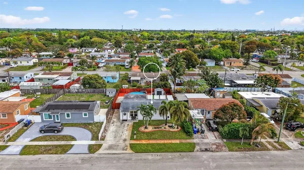 an aerial view of residential houses with city view