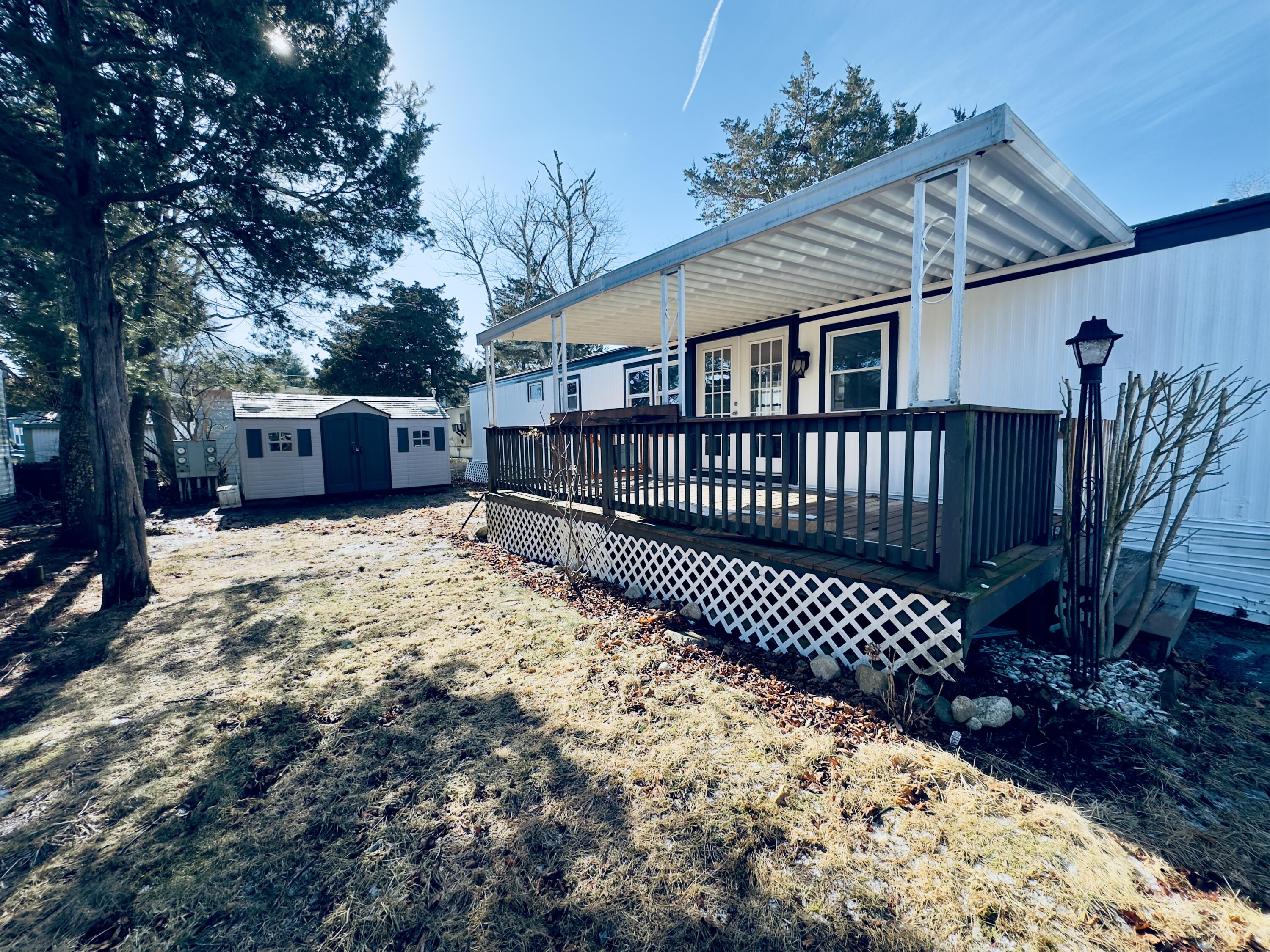 5 3rd Avenue Bourne, MA 02559 - Photo 2 of 18 a view of a house with a wooden fence