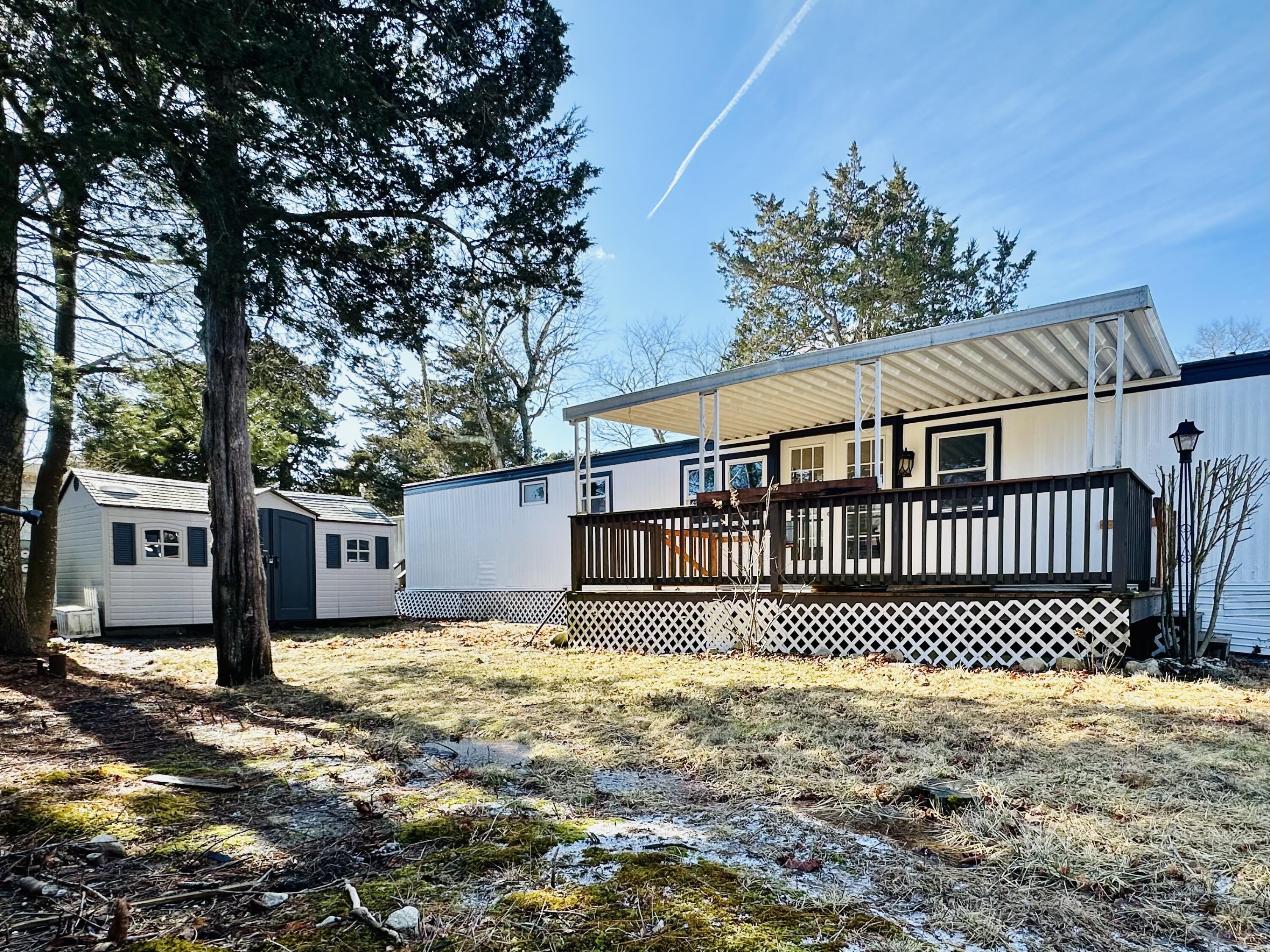 5 3rd Avenue Bourne, MA 02559 - Photo 3 of 18 a front view of a house with a garden