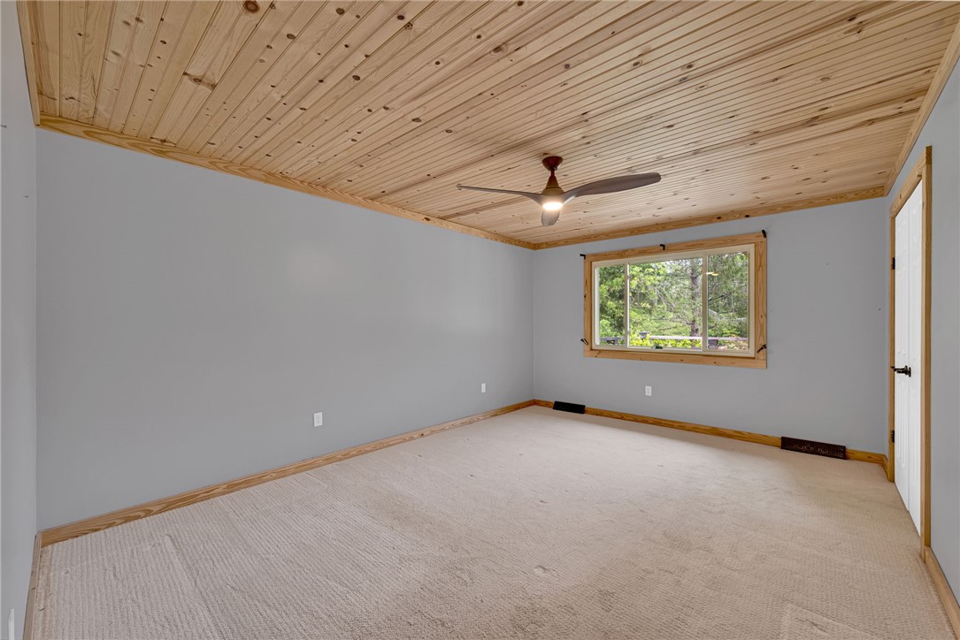 433 Latham Road Easley, SC 29640 - Photo 24 of 50 A tranquil retreat with a charming wood-paneled ceiling and generous window inviting natural light.