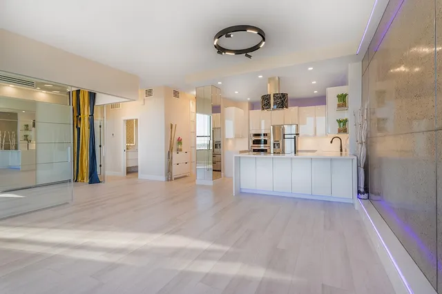 a view of a kitchen with a refrigerator and a microwave