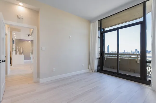a view of walk in closet with empty racks