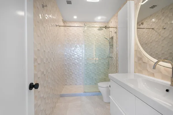 a bathroom with a toilet sink and shower