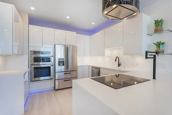 a kitchen with a sink stainless steel appliances and cabinets
