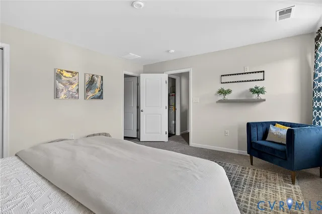 a bedroom with a bed and a painting on the wall