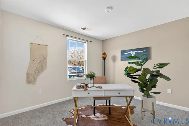 a view of a workspace with a table and chair in a room