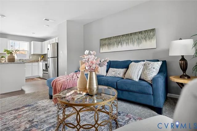 a living room with furniture and a painting