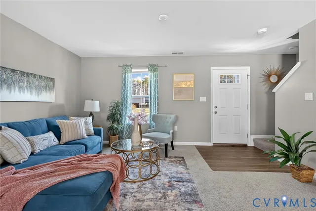 a living room with furniture and a potted plant