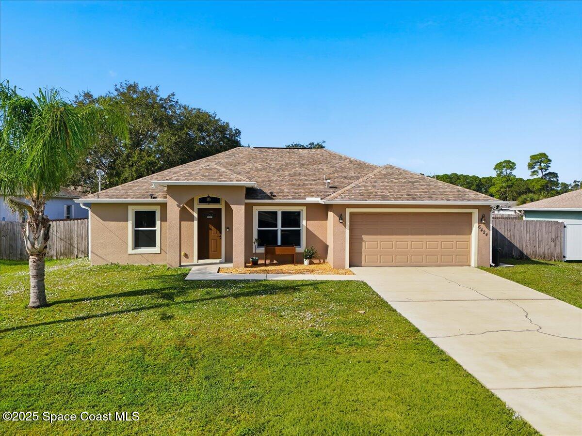 6424 Muller Avenue Cocoa, FL 32927 - Photo 1 of 33 a front view of a house with a yard
