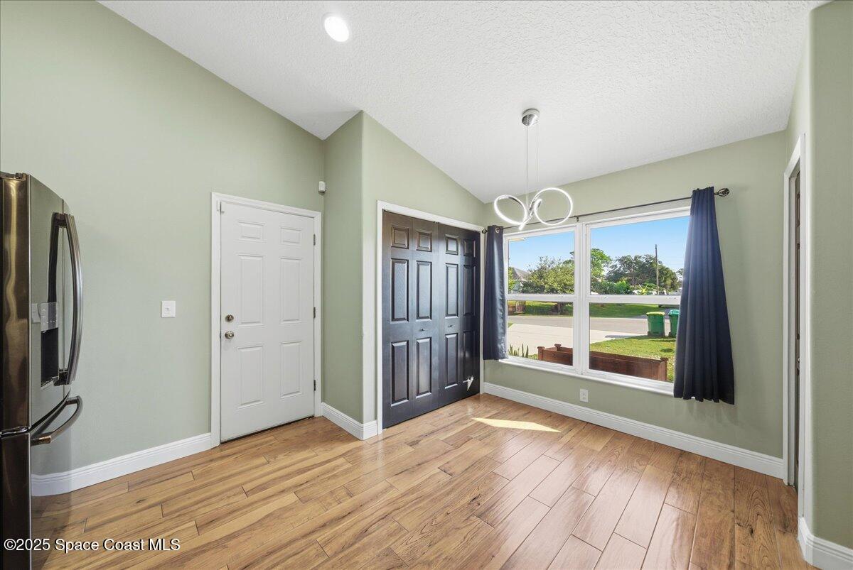 6424 Muller Avenue Cocoa, FL 32927 - Photo 11 of 33 an empty room with wooden floor and windows