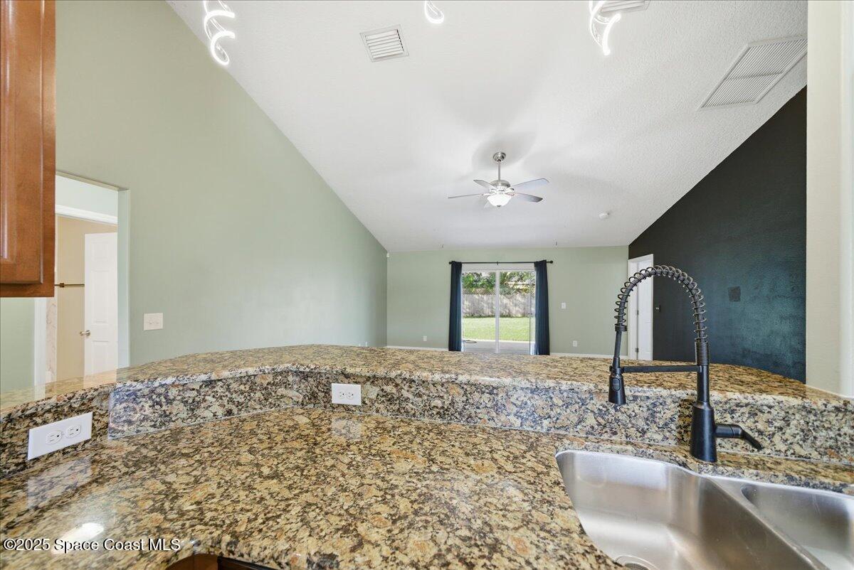 6424 Muller Avenue Cocoa, FL 32927 - Photo 14 of 33 a view of a bathroom with a sink and a mirror