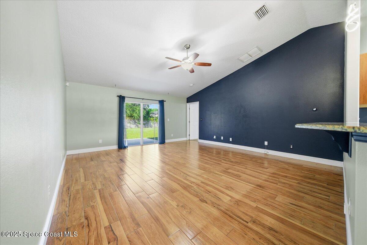6424 Muller Avenue Cocoa, FL 32927 - Photo 15 of 33 wooden floor in an empty room with a window
