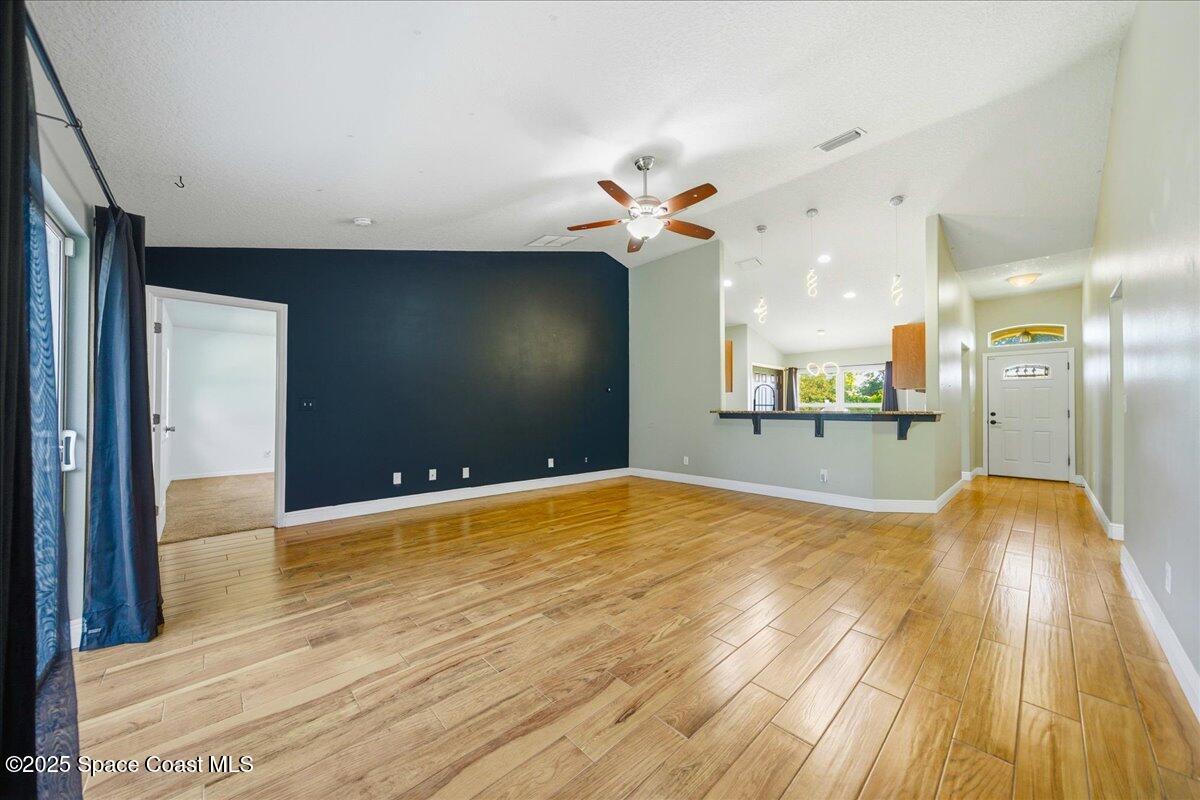 6424 Muller Avenue Cocoa, FL 32927 - Photo 16 of 33 a view of a big room with wooden floor and a bathroom