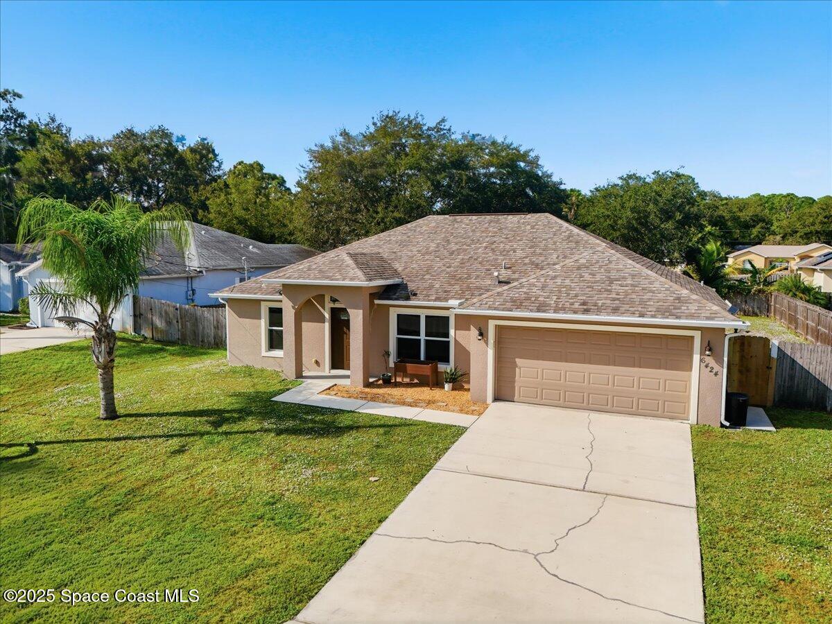 6424 Muller Avenue Cocoa, FL 32927 - Photo 2 of 33 a front view of a house with garden