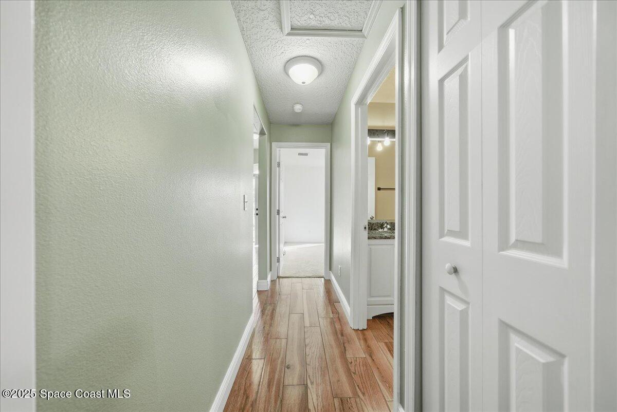 6424 Muller Avenue Cocoa, FL 32927 - Photo 22 of 33 a view of a hallway with wooden floor and entryway