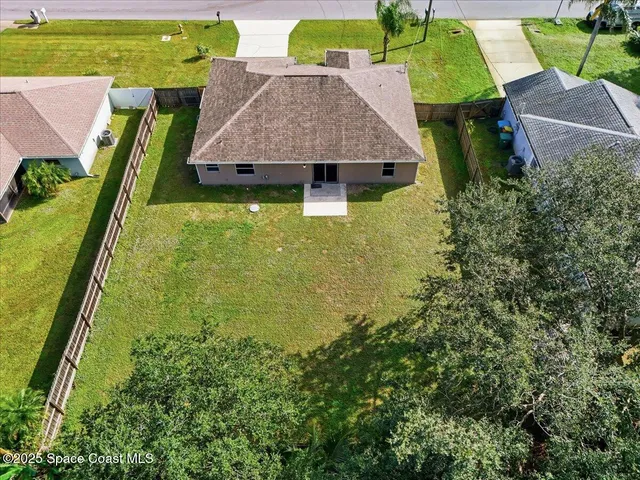 an aerial view of residential houses with outdoor space and swimming pool