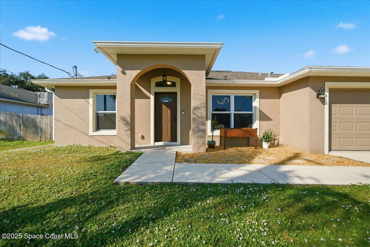 6424 Muller Avenue Cocoa, FL 32927 - Photo 3 of 33 a front view of a house with garden