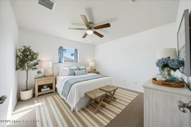 a bedroom with a bed and a potted plant