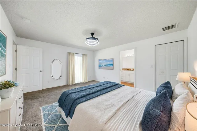 a bedroom with a bed and a potted plant