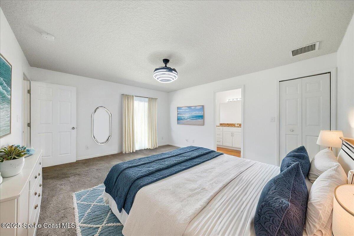 6424 Muller Avenue Cocoa, FL 32927 - Photo 6 of 33 a bedroom with a bed and a potted plant