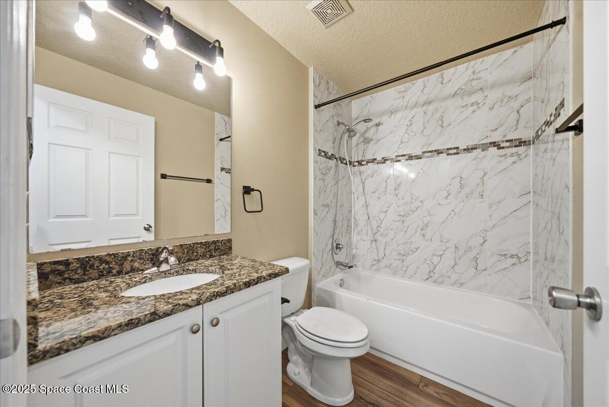 6424 Muller Avenue Cocoa, FL 32927 - Photo 8 of 33 a bathroom with a granite countertop sink toilet and shower