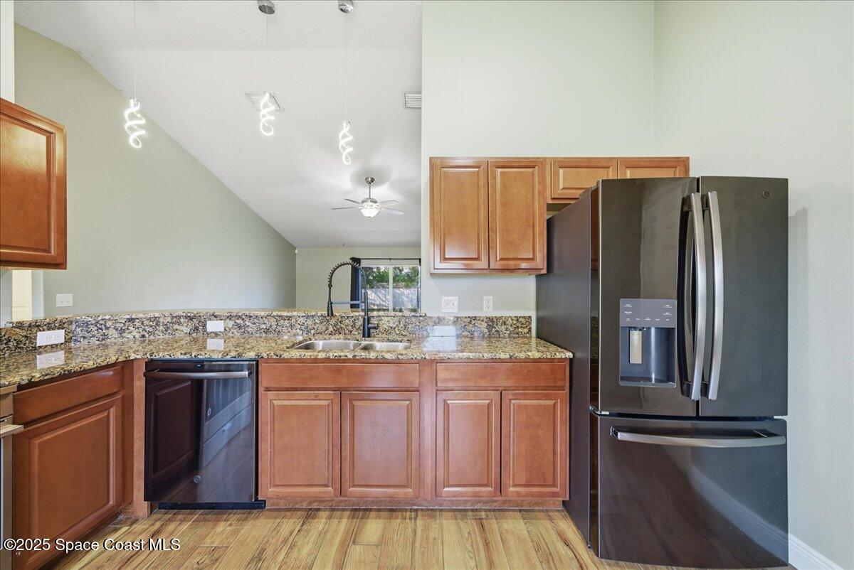6424 Muller Avenue Cocoa, FL 32927 - Photo 10 of 33 a kitchen with kitchen island granite countertop a refrigerator stove and sink