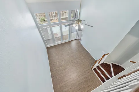 a view of staircase with white walls and railing