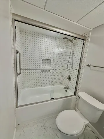 a bathroom with a toilet and shower