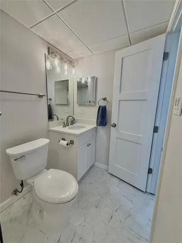 a white toilet sitting next to a bathroom sink