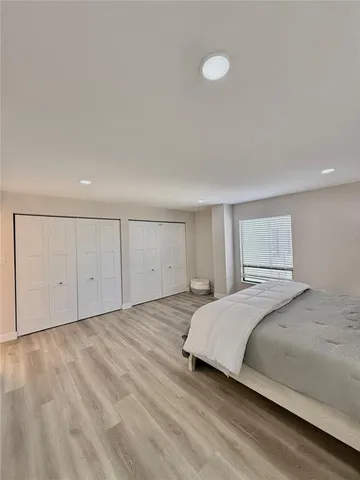 a bedroom with a bed and a night stand