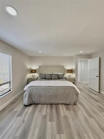 a spacious bedroom with a bed and window