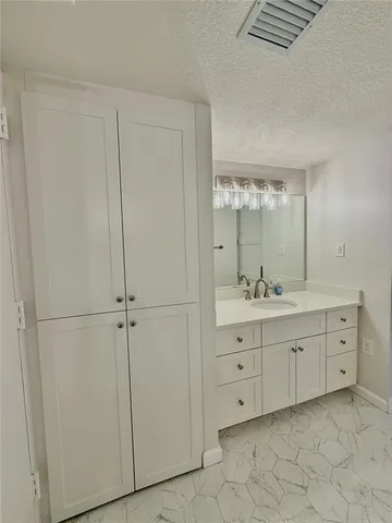 a bathroom with a double vanity sink and mirror