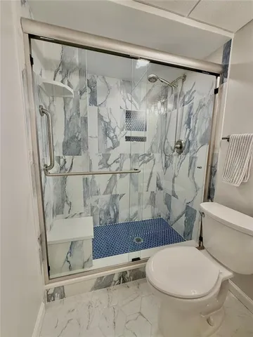 a bathroom with a toilet and shower