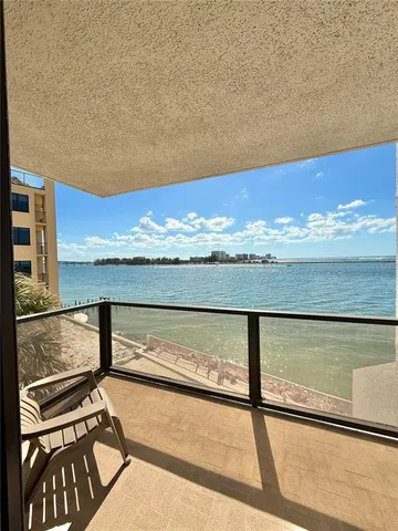 a living room with wooden floor and shelf